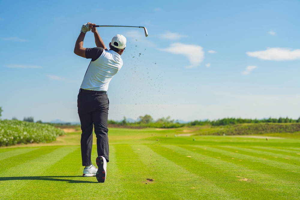 A golfer on his follow through after a shot from the fairway with one of his irons. - Boyd Honda Oxford, NC