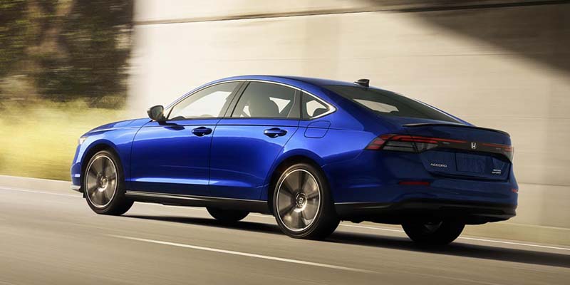 A blue 2024 Honda Accord driving on a state highway beneath an overpass. - Boyd Honda Oxford, NC