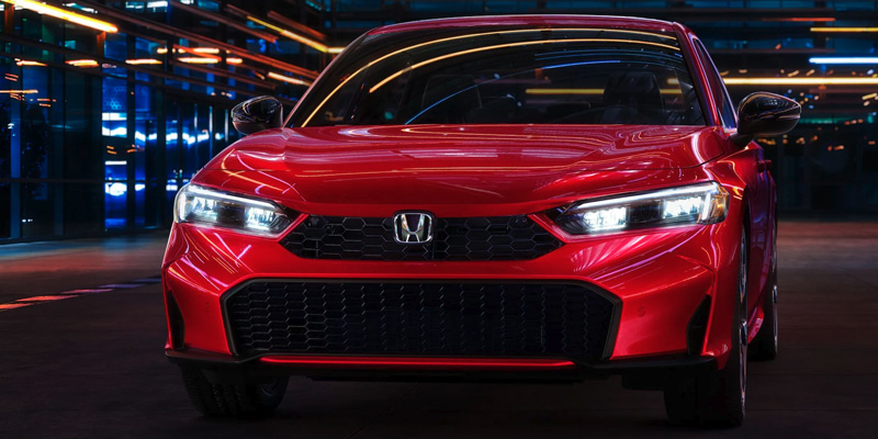 View of the front grill of a red 2025 Honda Civic Hatchback