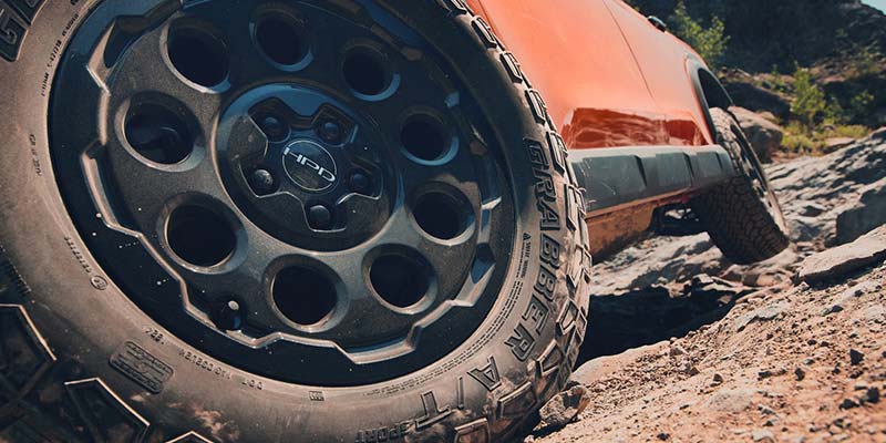 Wheel of a 2026 Honda Passport TrailSport navigating rocky off-road terrain near Oxford, NC